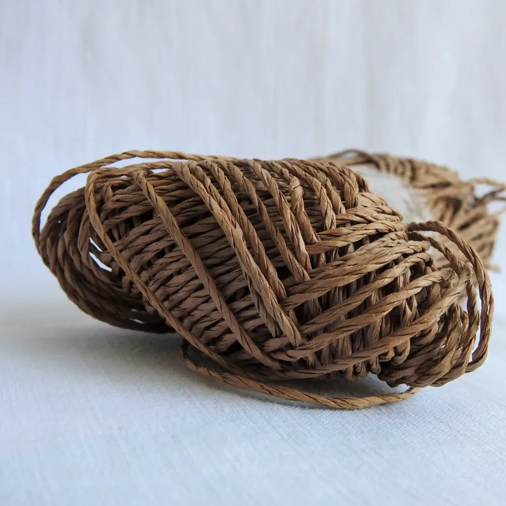 
                  
                    Skein of Sasawashi Bamboo Paper yarn in #9 Brown. Daruma Bamboo yarn for summer hats, bags, baskets. Eco friendly, vegan yarn for weaving, knitting, crochet, craft. Daruma Ito Yokota Sasawashi.
                  
                