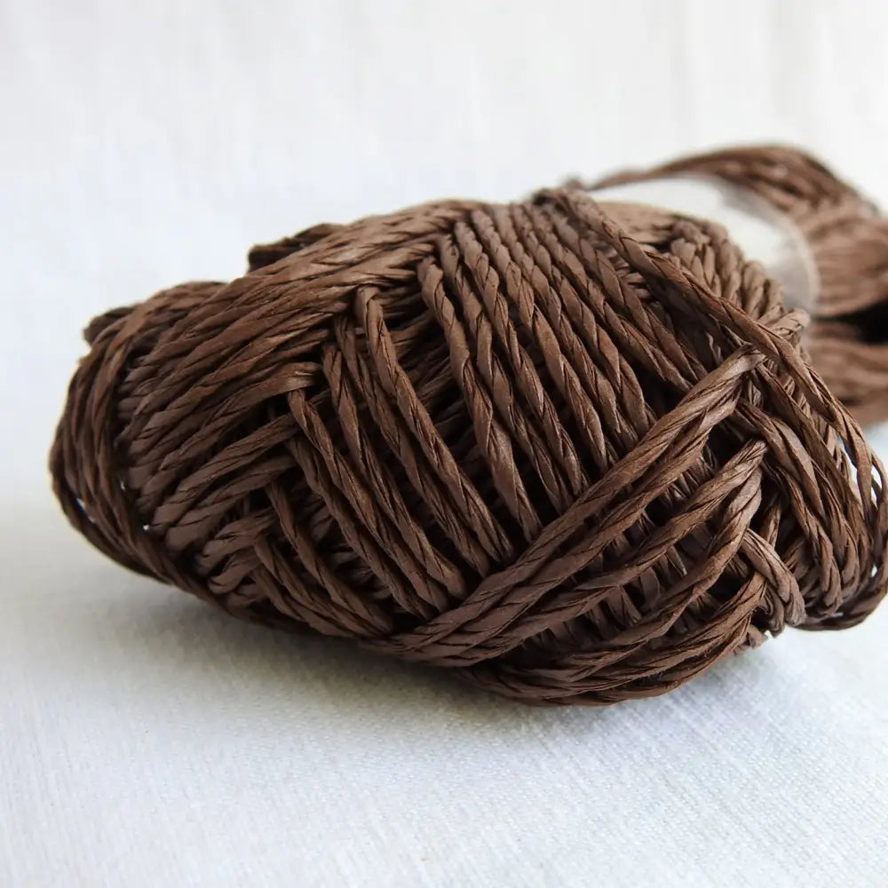 
                  
                    Skein of Sasawashi Bamboo Paper yarn in #13 dark brown. Daruma Bamboo yarn for summer hats, bags, baskets. Eco friendly, vegan yarn for weaving, knitting, crochet, craft. Daruma Ito Yokota Sasawashi.
                  
                