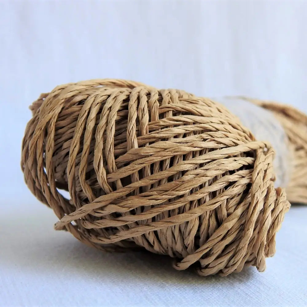 
                  
                    Skein of Sasawashi Bamboo Paper yarn in #2 Light Brown. Daruma Bamboo yarn for summer hats, bags, baskets. Eco friendly, vegan yarn for weaving, knitting, crochet, craft. Daruma Ito Yokota Sasawashi.
                  
                