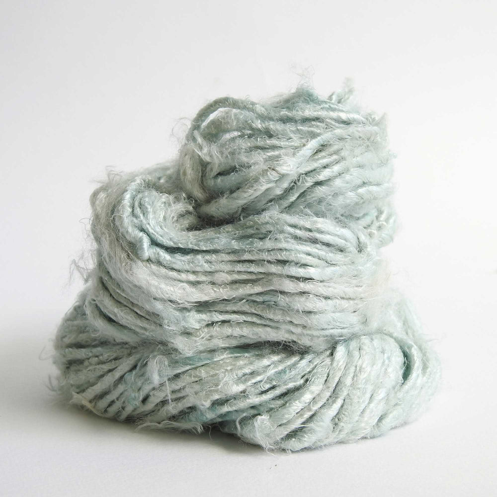 
                  
                    A ball of Banana Silk Yarn in Sage. Natural, vegan banana fiber yarn for weaving, punch needle, knitting, crochet. Soft, squishy, chunky yarn.
                  
                