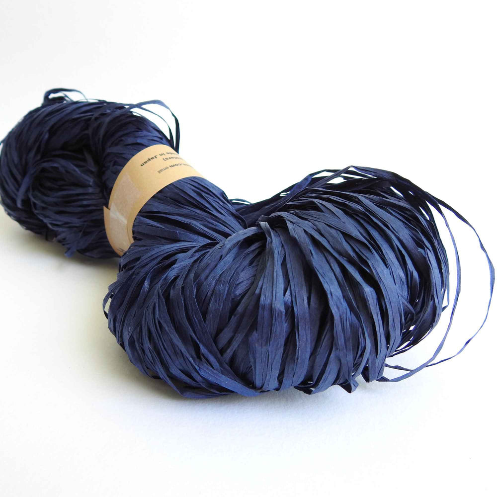 Skein of Habu Textiles Linen Paper yarn in Indigo. Linen Paper tape yarn is light, durable and strong and creates beautiful fabrics which are comfortable to wear.  Japanese paper yarn for weaving, crochet, knitting, textile arts, jewellery. Habu Textiles Linen Paper "Shigoki" yarn N-14