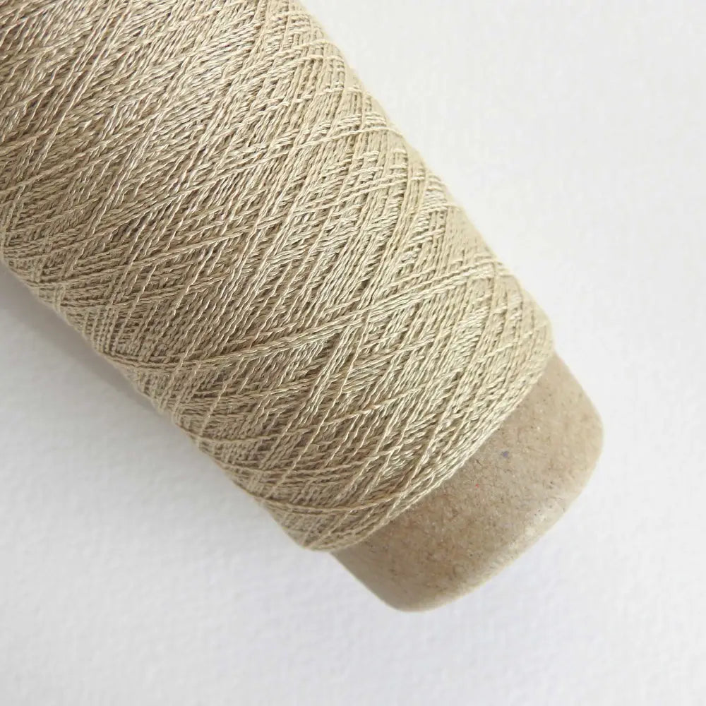 
                  
                    A cone of Silk Stainless Steel lace weight yarn in Beige for knitting crochet and weaving. Make beautiful scarves, garments and jewelry. The yarn has a stainless steel core with fine silk wrapped around it. They cone of yarn has a very elegant sheen and is beautiful to look at. Habu Textiles A20
                  
                