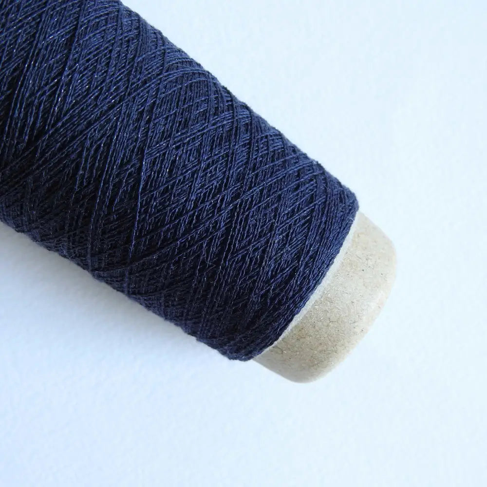 
                  
                    A cone of Silk Stainless Steel lace weight yarn in Navy for knitting crochet and weaving. Make beautiful scarves, garments and jewelry. The yarn has a stainless steel core with fine silk wrapped around it. They cone of yarn has a very elegant sheen and is beautiful to look at. Habu Textiles A20
                  
                