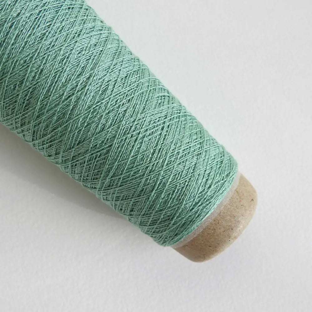 
                  
                    A cone of Silk Stainless Steel lace weight yarn in Seafoam for knitting crochet and weaving. Make beautiful scarves, garments and jewelry. The yarn has a stainless steel core with fine silk wrapped around it. They cone of yarn has a very elegant sheen and is beautiful to look at. Habu Textiles A20
                  
                