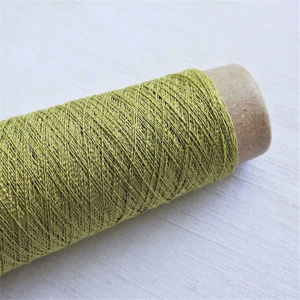 
                  
                    A cone of Silk Stainless Steel lace weight yarn in Tea Green for knitting crochet and weaving. Make beautiful scarves, garments and jewelry. The yarn has a stainless steel core with fine silk wrapped around it. They cone of yarn has a very elegant sheen and is beautiful to look at. Habu Textiles A20
                  
                