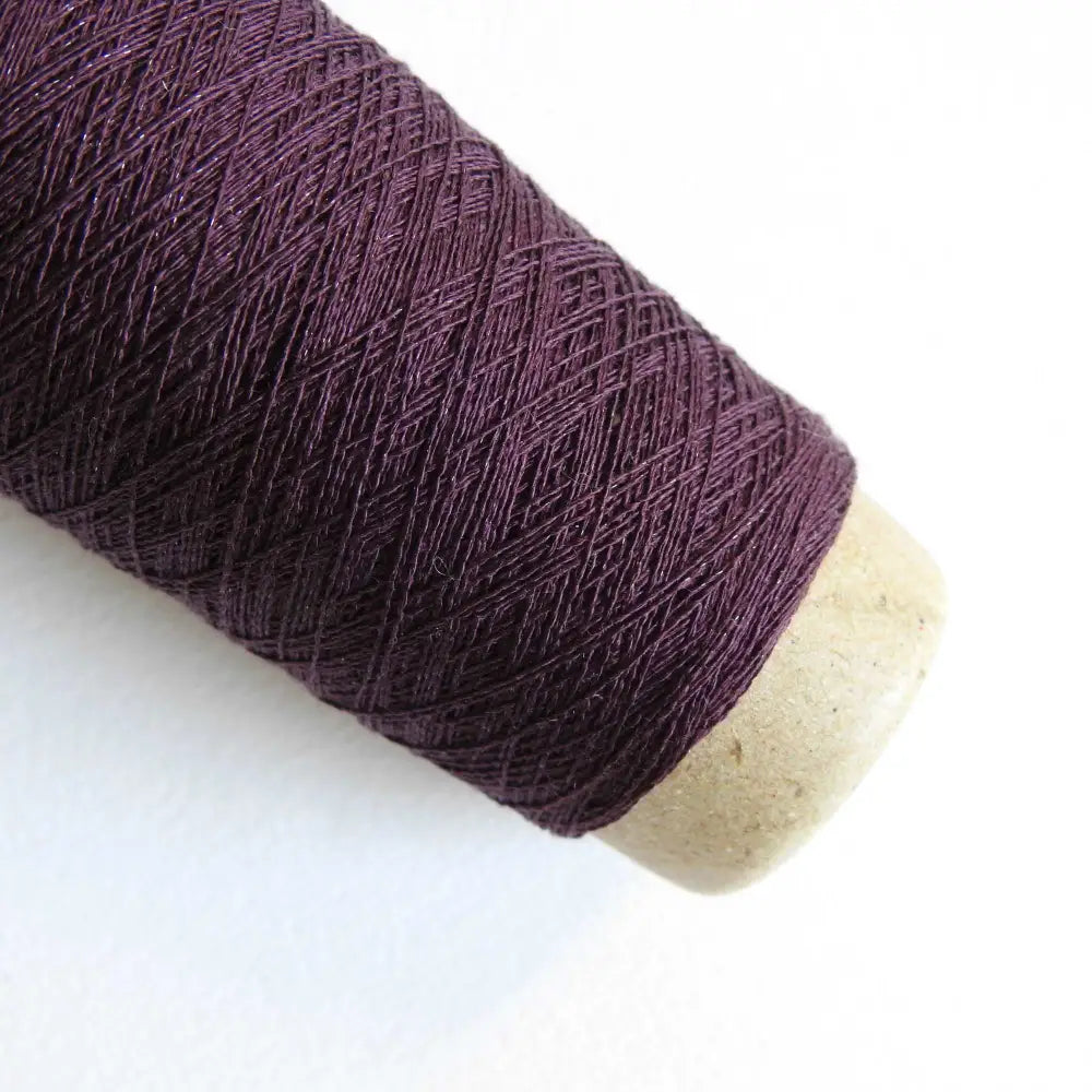 
                  
                    A cone of Silk Stainless Steel lace weight yarn in Violet for knitting crochet and weaving. Make beautiful scarves, garments and jewelry. The yarn has a stainless steel core with fine silk wrapped around it. They cone of yarn has a very elegant sheen and is beautiful to look at. Habu Textiles A20
                  
                