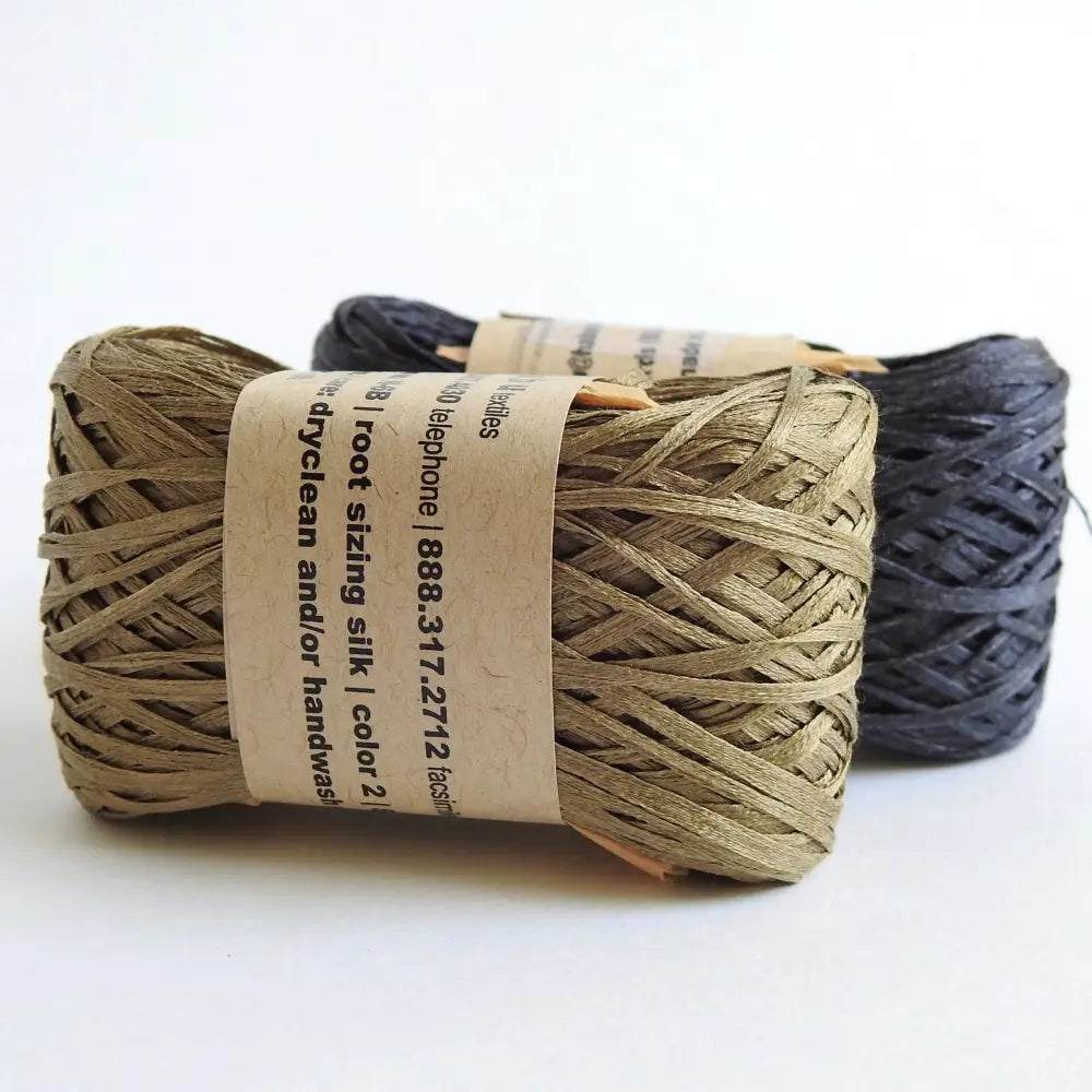 
                  
                    Balls of Habu Silk Tape Yarn in Khaki and Charcoal. 100% Japanese silk yarn for knitting, crochet, weaving. Make hats, bags, garments, shawls. Silky and luminous fine tape. Habu Textiles N-6B
                  
                