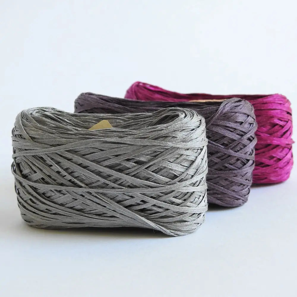 
                  
                    Balls of Habu Silk Tape Yarn in Grey, Purple and Fuschia. 100% Japanese silk yarn for knitting, crochet, weaving. Make hats, bags, garments, shawls. Silky and luminous fine tape. Habu Textiles N-6B
                  
                