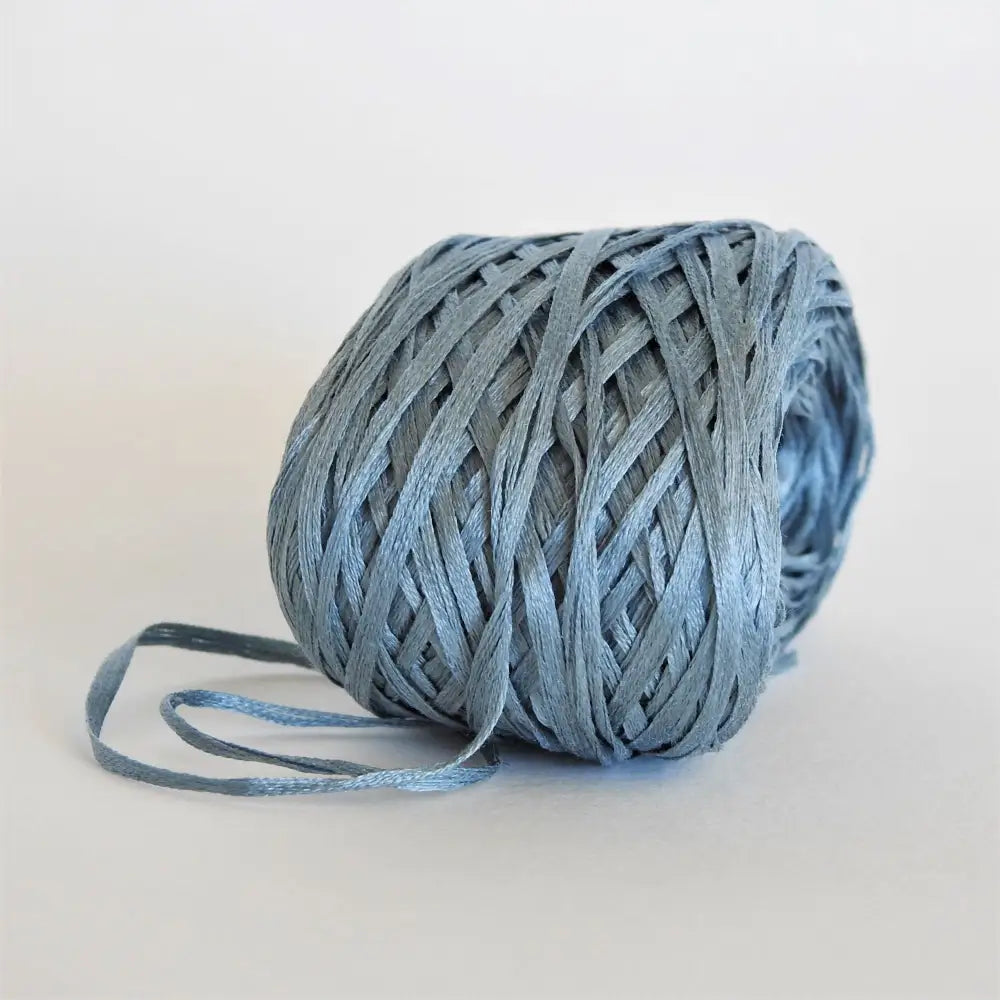 
                  
                    Ball of Habu Silk Tape Yarn in Gray Blue. 100% Japanese silk yarn for knitting, crochet, weaving. Make hats, bags, garments, shawls. Silky and luminous fine tape. Habu Textiles N-6B
                  
                
