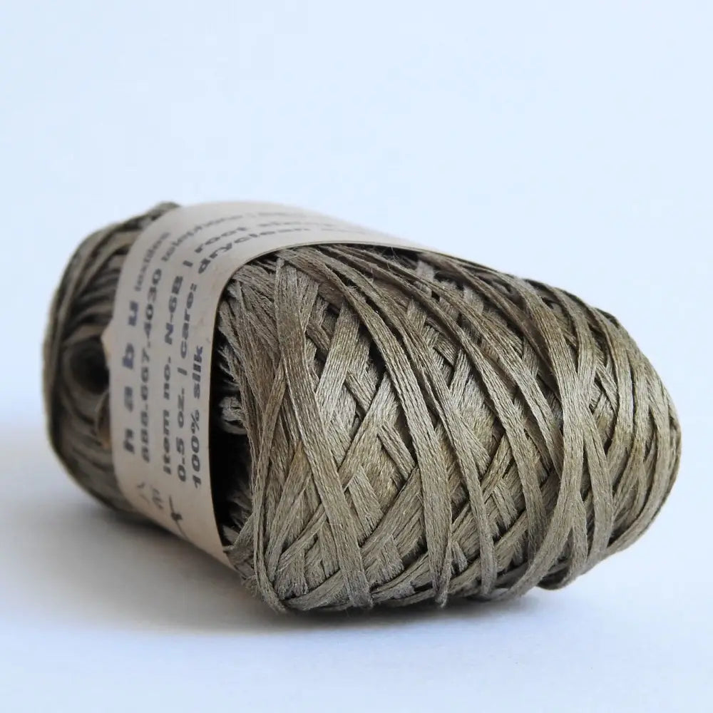 
                  
                    Ball of Habu Silk Tape Yarn in Khaki. 100% Japanese silk yarn for knitting, crochet, weaving. Make hats, bags, garments, shawls. Silky and luminous fine tape. Habu Textiles N-6B
                  
                