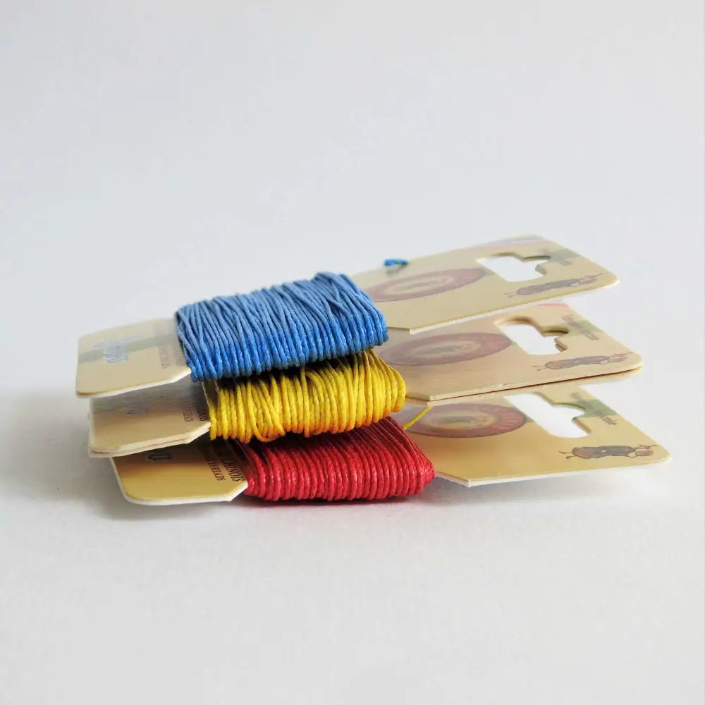 
                  
                    Cards of waxed linen thread in Royal Blue, Sunshine and Red.  Wax linen thread for beading, jewellery, leather sewing, book binding, bracelets. Heavy duty thread. Size 432. Fil au Chinois waxed Linen from Maison Sajou. 
                  
                