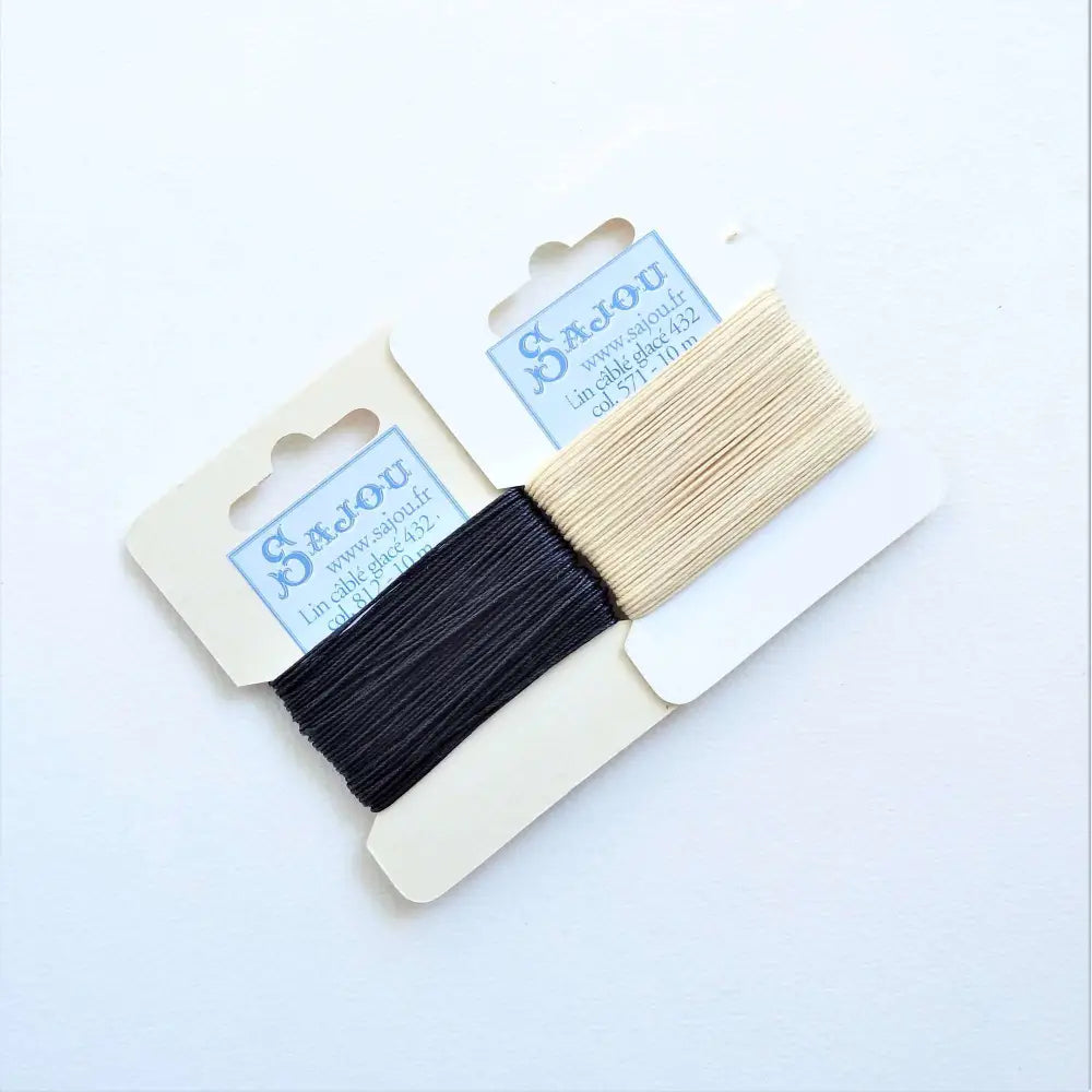 
                  
                    Cards of waxed linen thread in Marine and Ecru.  Wax linen thread for beading, jewellery, leather sewing, book binding, bracelets. Heavy duty thread. Size 432. Fil au Chinois waxed Linen from Maison Sajou. 
                  
                