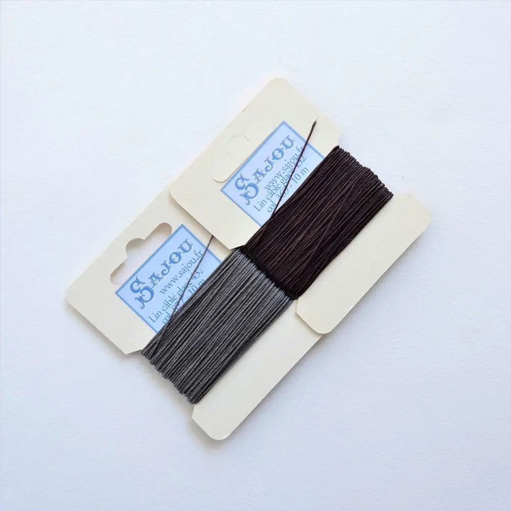 
                  
                    Cards of waxed linen thread in Slate and Soil.  Wax linen thread for beading, jewellery, leather sewing, book binding, bracelets. Heavy duty thread. Size 432. Fil au Chinois waxed Linen from Maison Sajou. 
                  
                