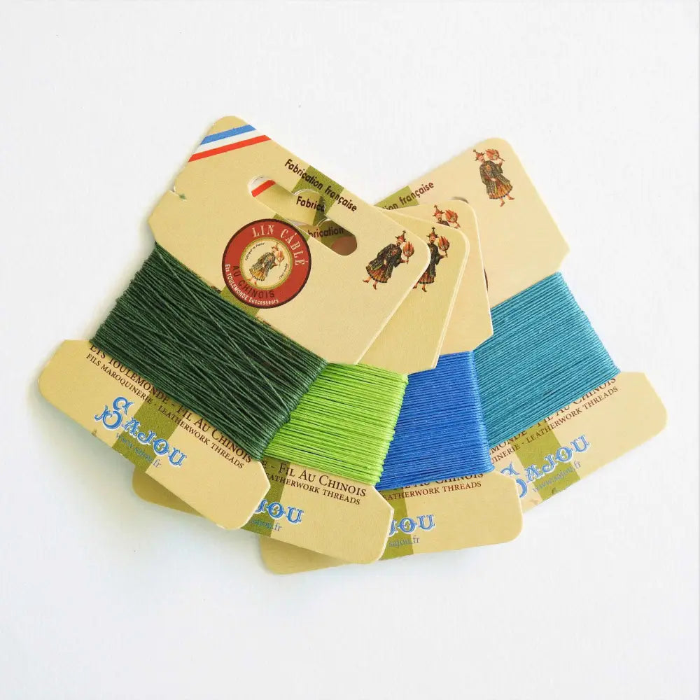 
                  
                    Cards of waxed linen thread in shades of green and blue.  Wax linen thread for beading, jewellery, leather sewing, book binding, bracelets. Heavy duty thread. Size 832. Fil au Chinois waxed Linen from Maison Sajou. 
                  
                